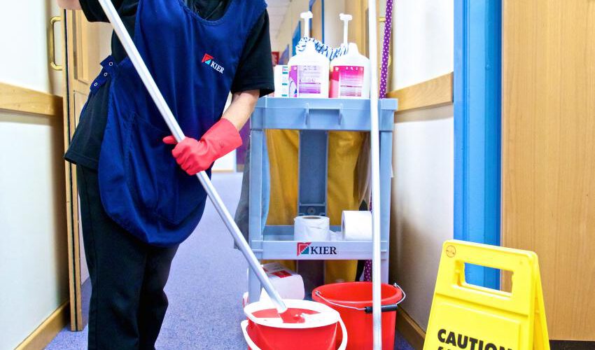 A Kier employee cleaning offices using products supplied by Bunzl Cleaning and Hygiene Supplies, Bunzl UK & Ireland